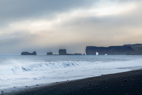 View of Rock Formations and Waves Washing Up the Beach in Iceland