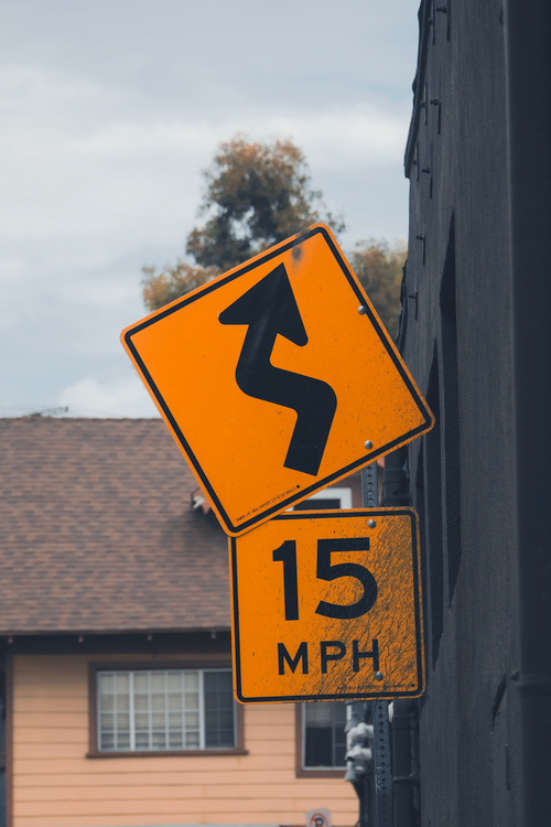 Free Curvy road sign with speed limit in suburban Los Angeles, CA. Stock Photo