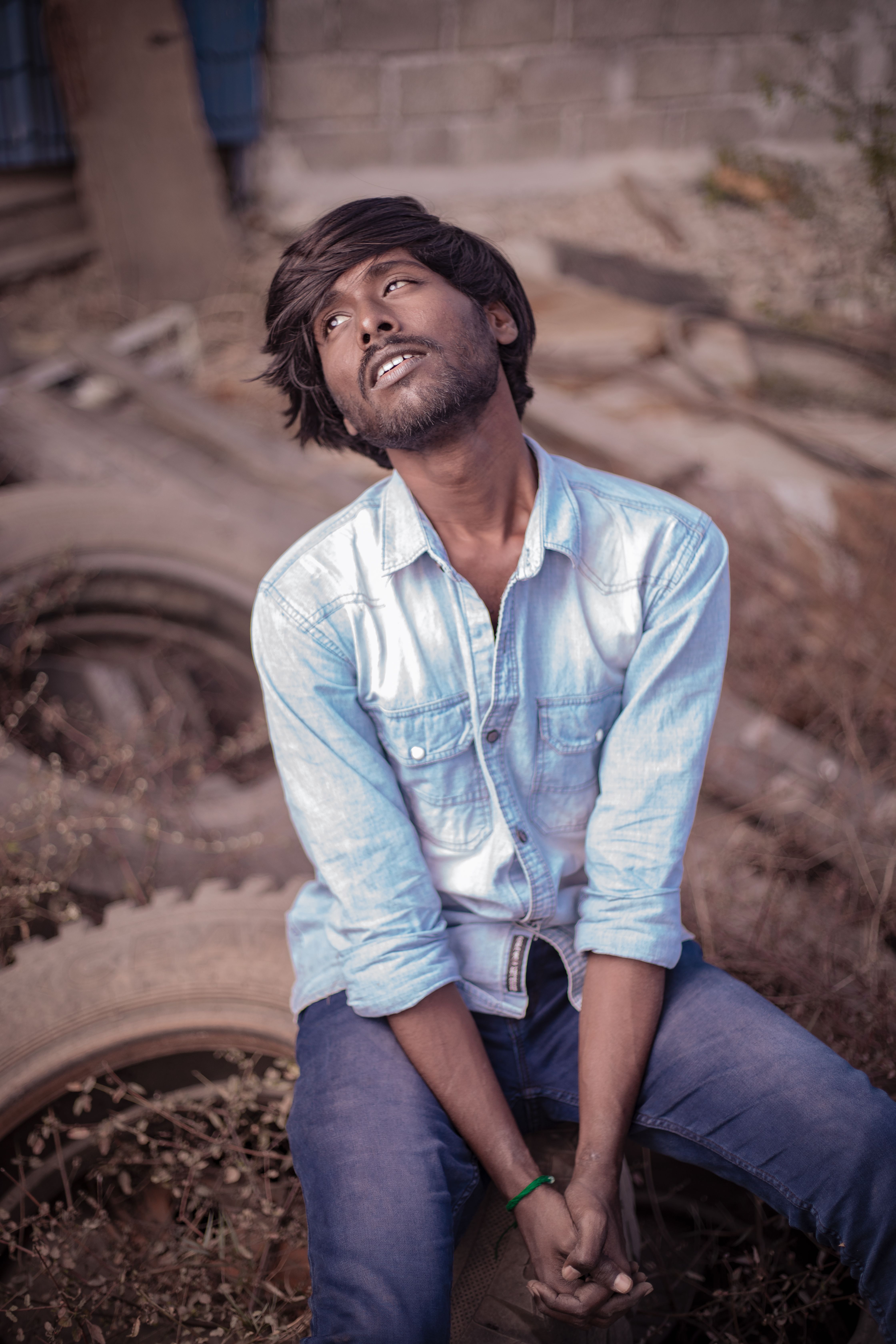A stylish young man poses outdoors in Chennai, captured with a modern and vibrant tone.