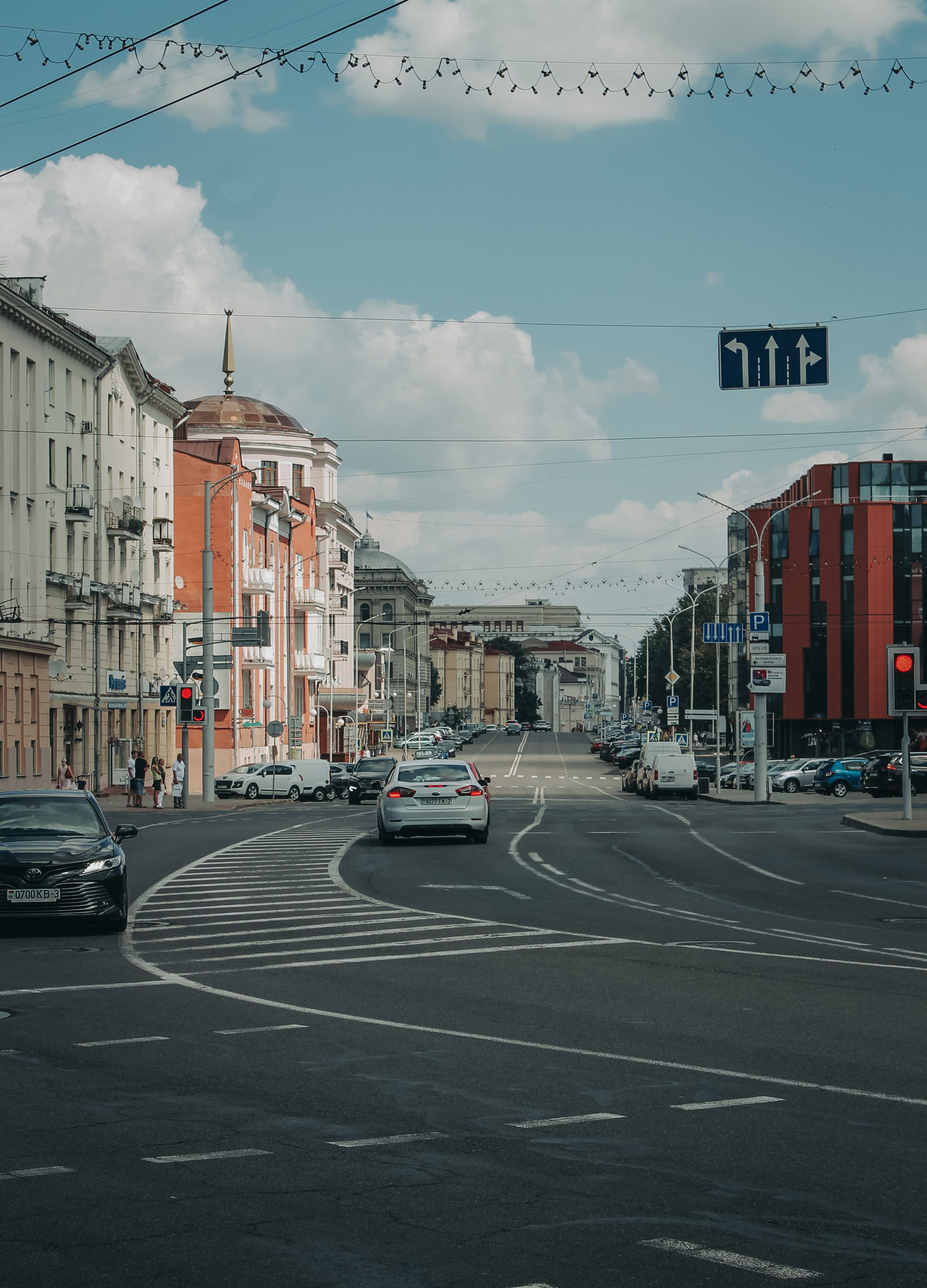 View of Cars on a Street between Buildings in City · Free Stock Photo