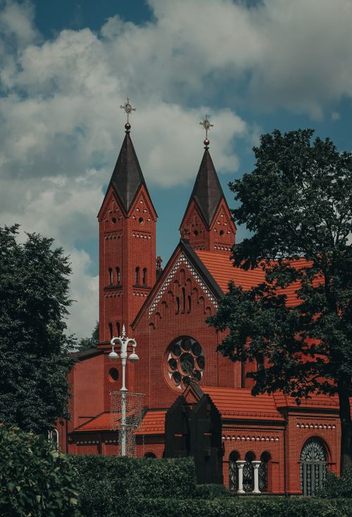 Free Captivating red brick church with twin towers in sunny Minsk showcasing architectural elegance. Stock Photo