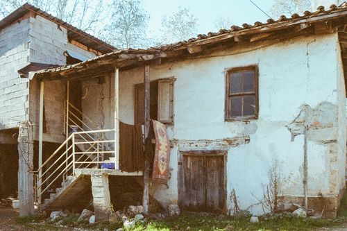 Free A rundown, rustic house with a weathered facade reflecting rural charm and decay. Stock Photo