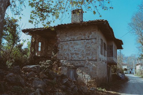 Free An old, abandoned stone house in a rural setting, surrounded by nature. Stock Photo