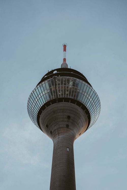 Free Low angle view of Rheinturm Tower in Düsseldorf against a clear blue sky. Stock Photo