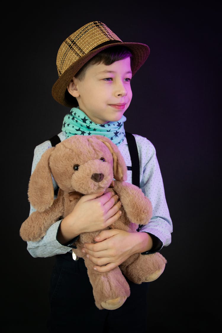 A Boy Holding A Teddy Bear 