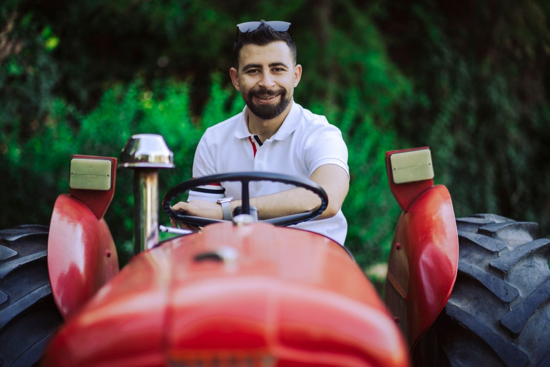 Man Riding a Red Tractor · Free Stock Photo
