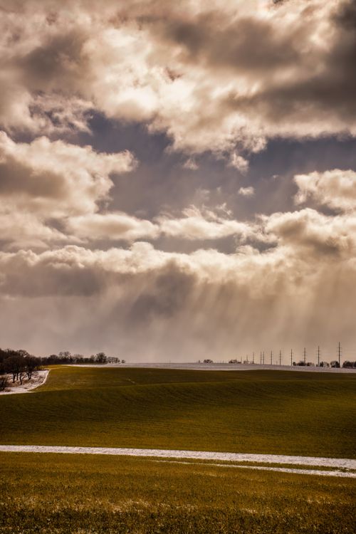 Free A peaceful MN countryside landscape with sunbeams breaking through dramatic clouds. Stock Photo