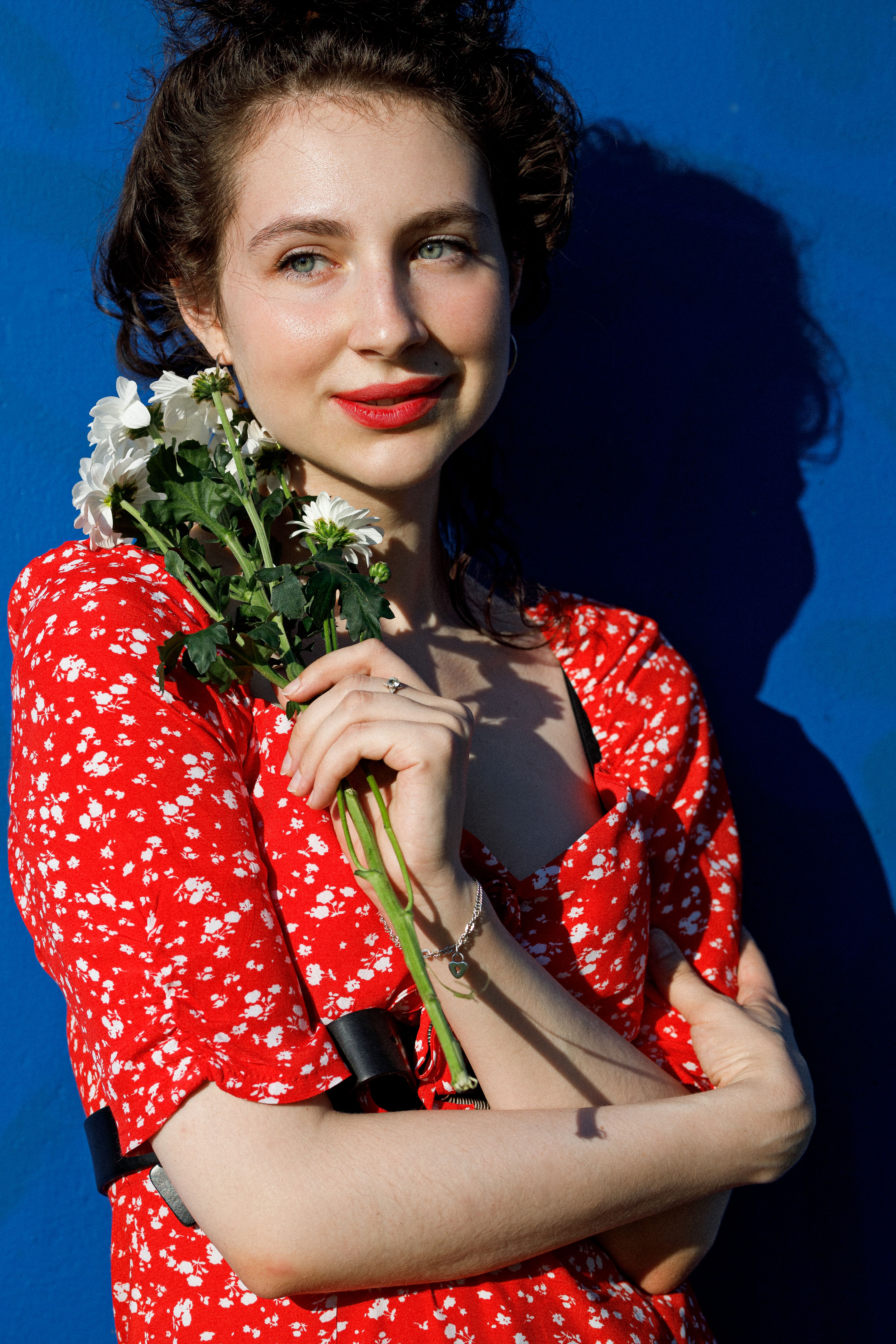 Woman in Red Floral Dress Holding White Flowers  Free Stock Photo