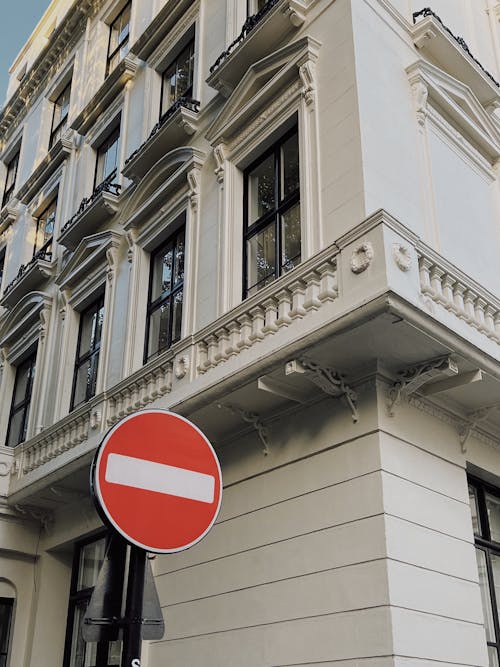 Red Stop Sign at Street Corner by Building