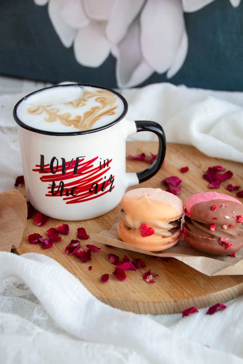 Cup of Coffee and Macaroons Lying on Wooden Cutting Board