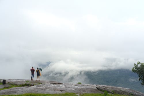 Two People Standing Above a Valley