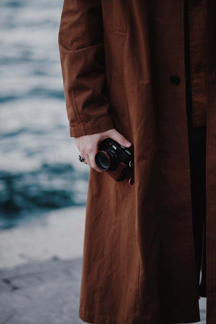 Woman Holding A Camera In Her Hand 