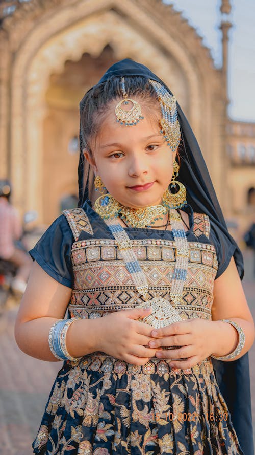 Girl in Traditional Costume Posing Outdoors