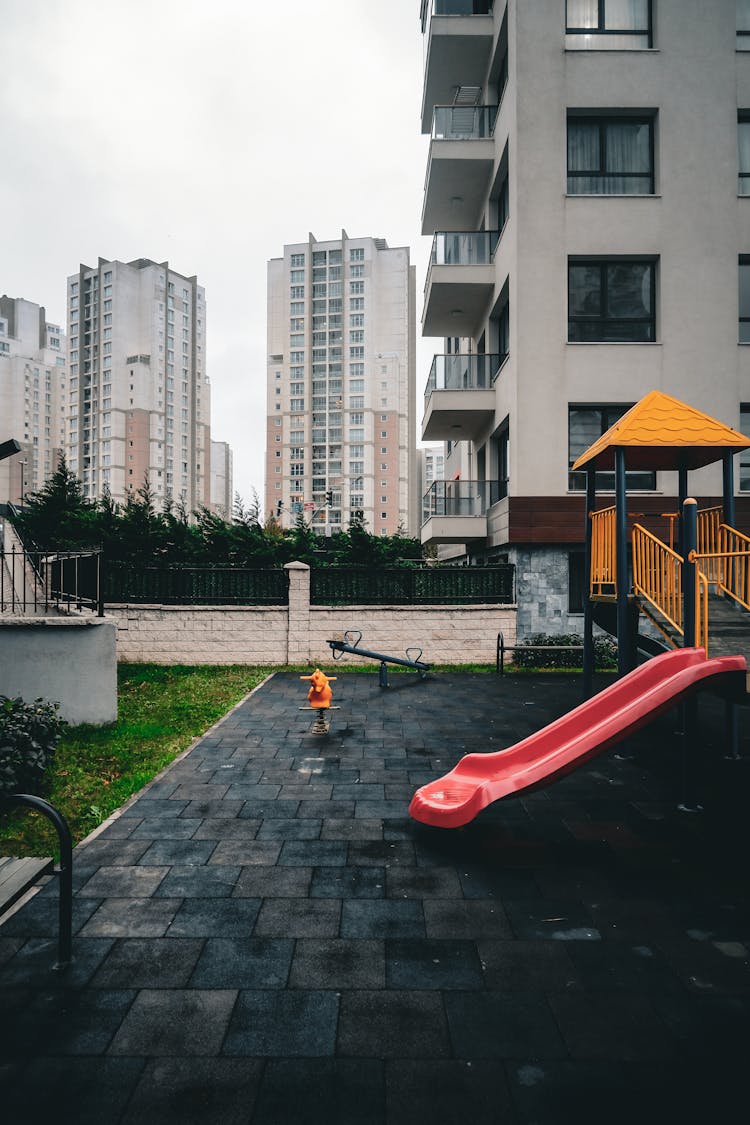 A Playground Outside The Apartment Buildings