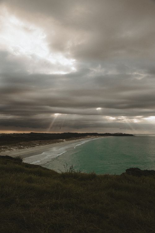 Free Captivating view of clouds and coastline at Puheke Beach during the day. Stock Photo