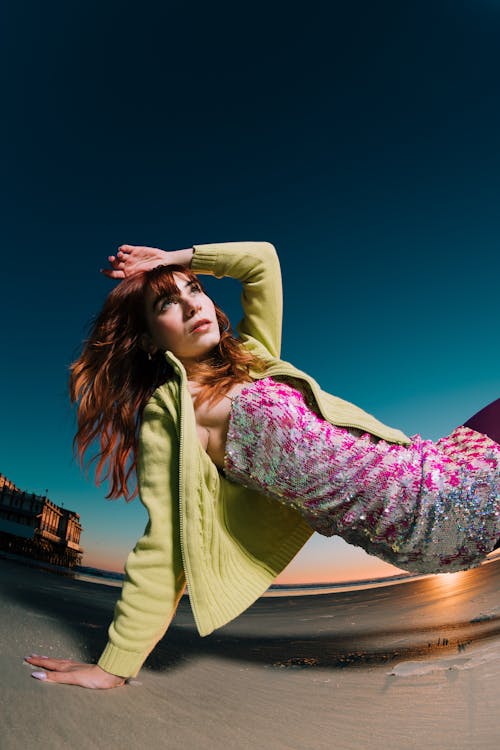 Pretty Redhead Posing on a Beach at Sunset