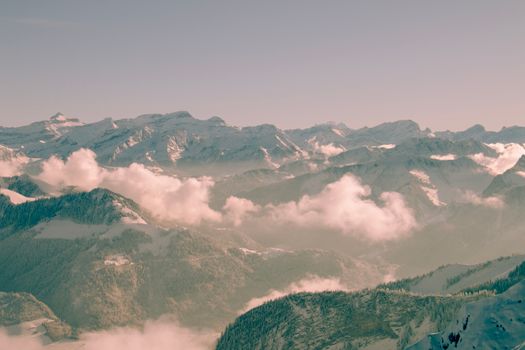 A breathtaking view of a snowcapped mountain range under a cloudy sky, perfect for travel enthusiasts.