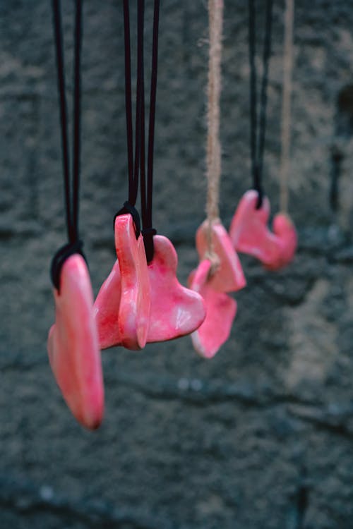 Necklaces Hanging Near Concrete Wall