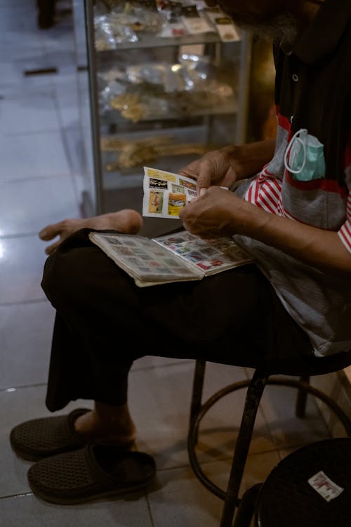 A Man Sitting while Looking at the Stickers
