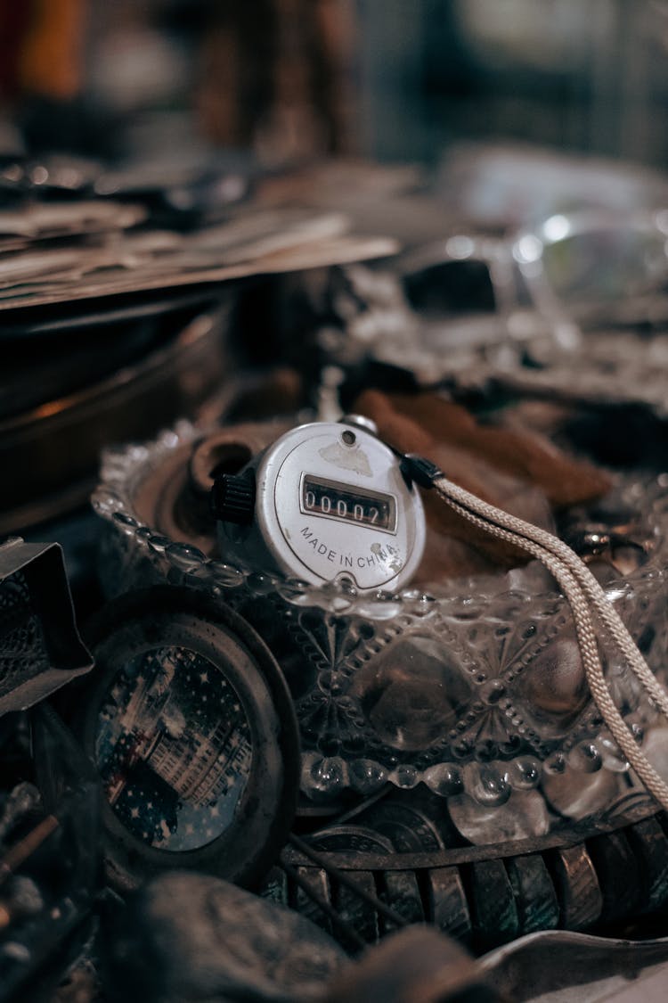 Mechanical Tally Counter On A Pile Of Old Trinkets