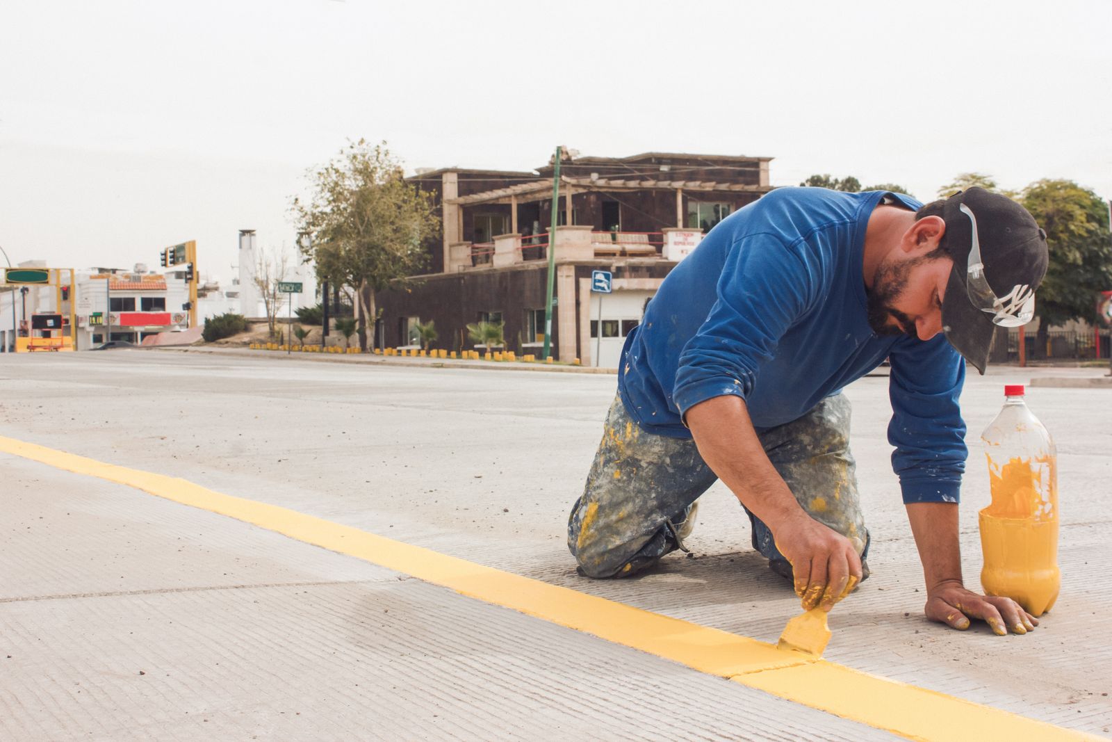 Worker painting road markings