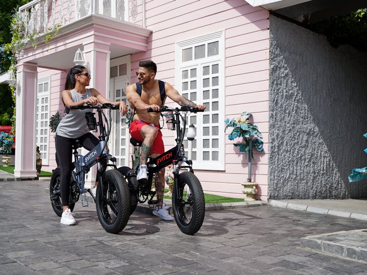 Man And Woman Riding Electric Bikes