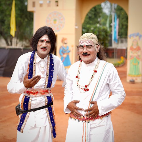 Free Men in Traditional Costumes near Temple Stock Photo