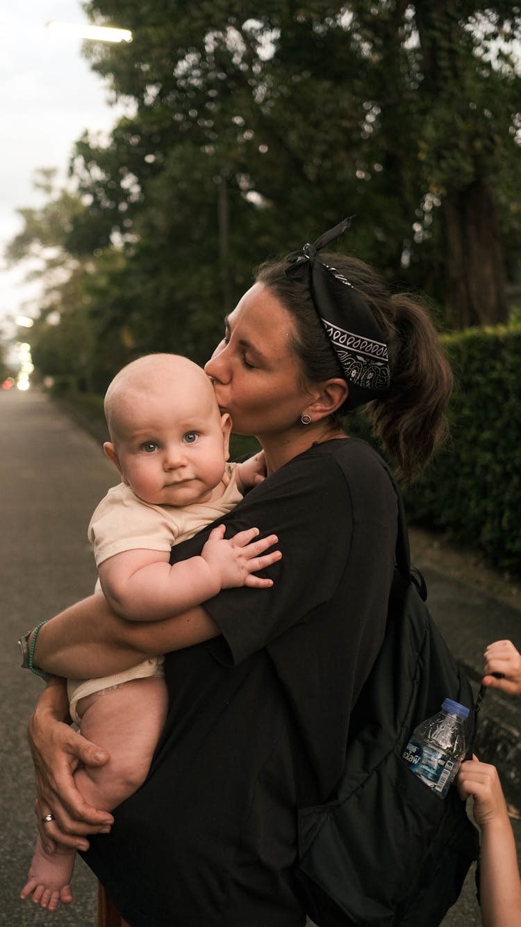 A Mother Kissing Her Baby