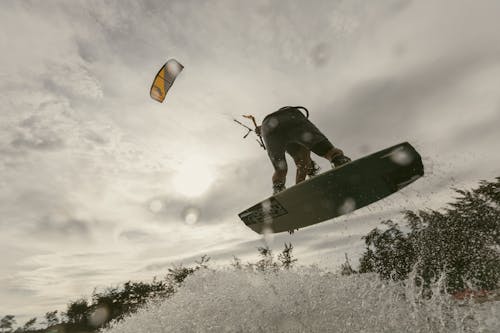 Low-Angle Shot of a Person Kiteboarding in the Sea