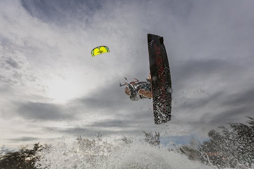Low-Angle Shot of a Person Kiteboarding in the Sea