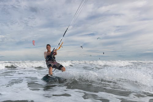 A Man Kiteboarding in the Sea