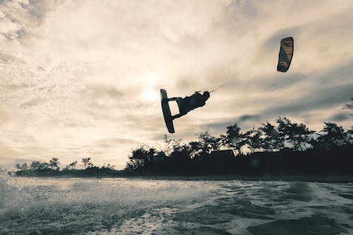 A Person Kiteboarding in the Sea