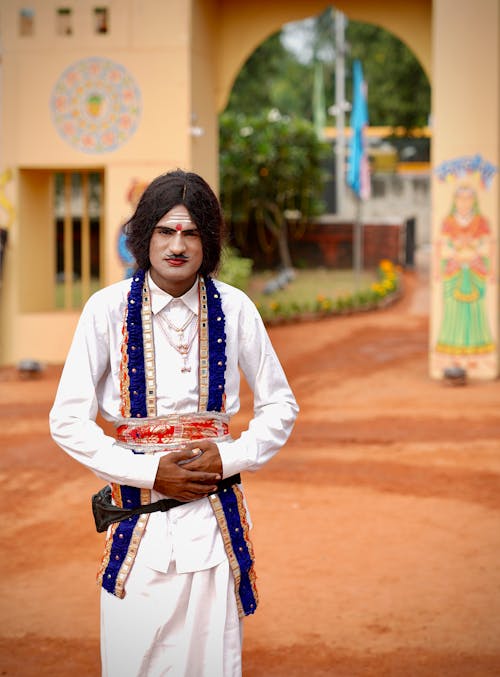 Man in Traditional Costume near Temple