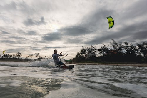 A Man Kiteboarding in the Sea