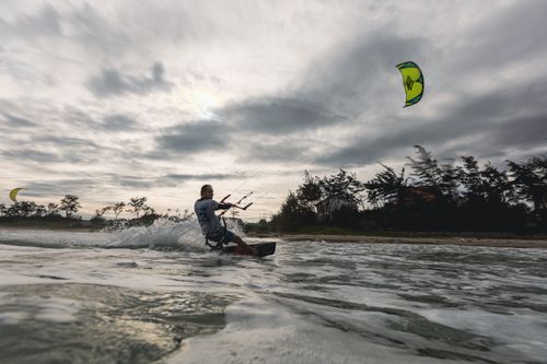 Free Experience the thrill of kiteboarding on the open sea, capturing motion and excitement. Stock Photo
