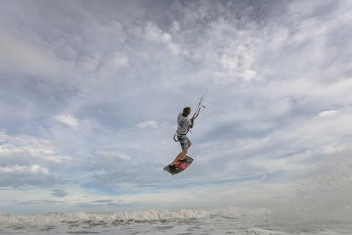 A Man Kitesurfing in the Sea