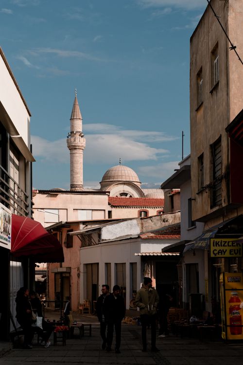 Free Discover a sunlit street view featuring a historical mosque in İzmir, Turkey. Perfect for travel inspiration. Stock Photo