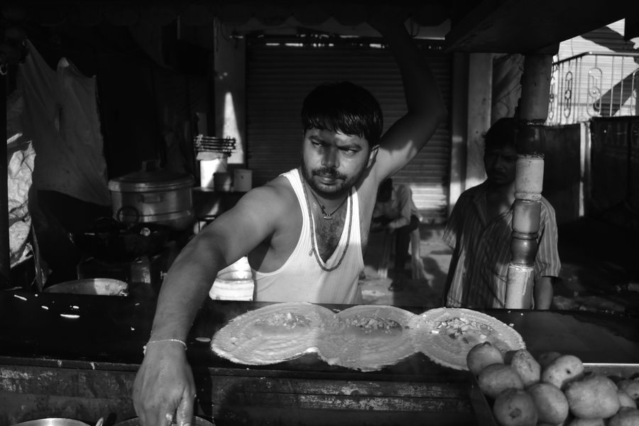 Man making traditional food at a street stall