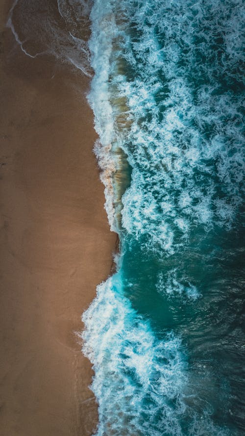 Top View of Waves Washing Up the Beach