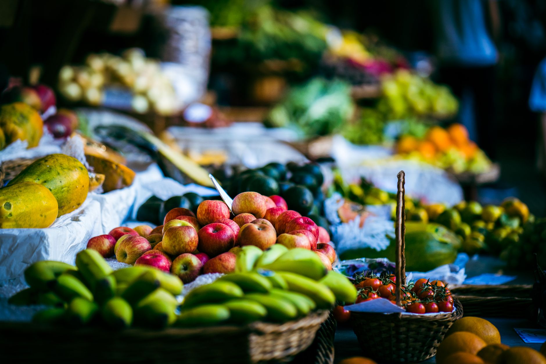 Colorful arrangement of fresh fruits at an outdoor market stall, offering a vibrant selection.