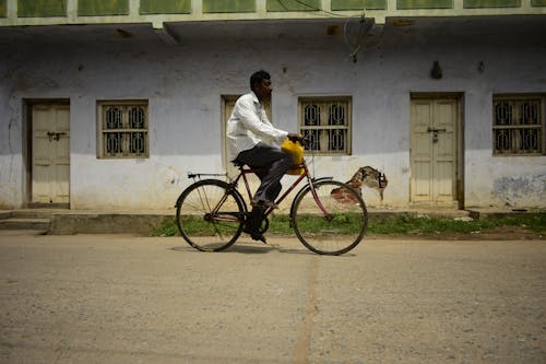 Man Riding on a Bicycle in a Town 