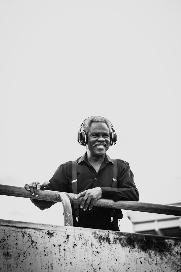 Grayscale Photo Of A Man Wearing Headset