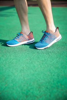 Stylish sneakers on a vibrant green surface, highlighting modern footwear design.