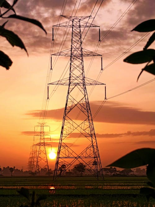 Tall Electric Transmission Towers in the Farm Field