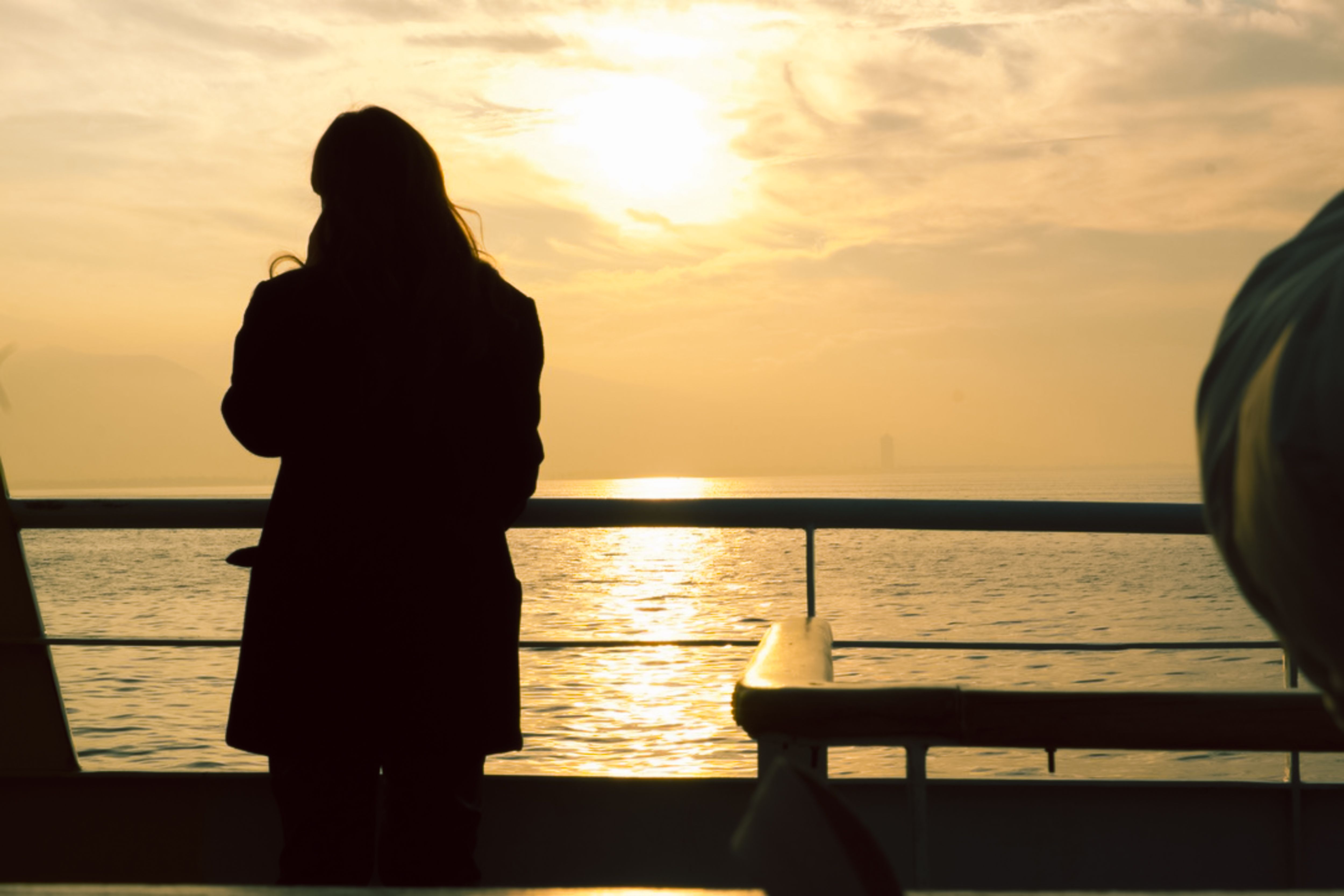 Woman Standing on Shore at Sunset · Free Stock Photo
