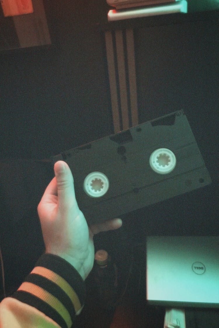 Hand Holding Cassette