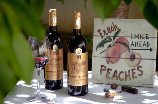 Two Red Wine Bottles Beside Clear Wine Glass