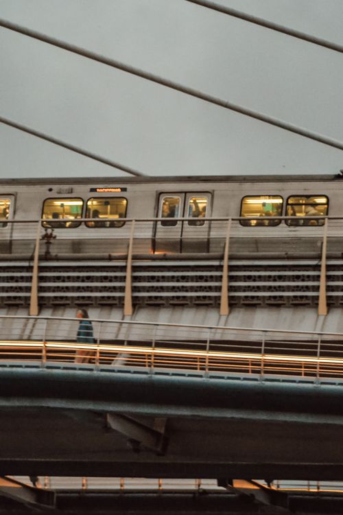 Free Istanbul metro train on Halic Bridge under overcast sky, capturing urban transportation. Stock Photo