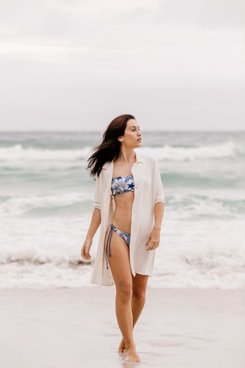 Woman in bikini posing on beach Stock Photo