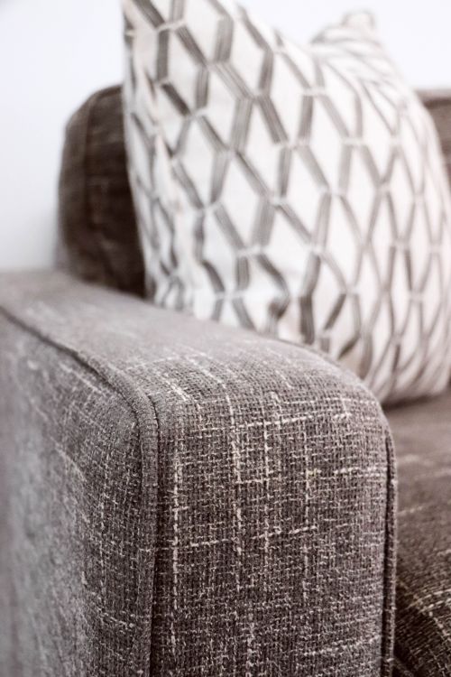 Free Modern sofa armrest with a geometric cushion design, perfect for interior decor. Stock Photo